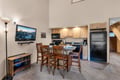 Your cozy open-concept retreat features a fully equipped kitchenette and casual dining space, perfect for relaxing après-ski meals together.