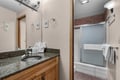 Step into your bathroom with granite countertops, warm wood cabinetry, and a well-lit vanity. The separate tub and shower offer flexibility for your morning routine or evening wind-down.