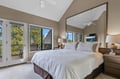 Upstairs Primary King Drift off in your bright master suite with vaulted ceilings, crisp linens, and private balcony access to forest views.