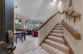 Step into your spacious retreat where vaulted ceilings and warm carpeted stairs lead to comfortable living spaces with mountain views.