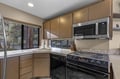 Your fully equipped kitchen features modern appliances and a bright window view, perfect for preparing meals during your stay.