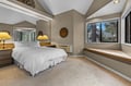B Unit- Hotel Lock off with King bed Sink into crisp white linens and enjoy peaceful tree views from your bright bedroom's window seat, perfect for morning coffee.