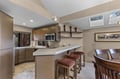 Your spacious kitchen welcomes you with sleek countertops, modern appliances, and a breakfast bar perfect for morning coffee under natural skylights.