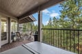 Main floor Deck with Hot tub. Unwind on your private deck overlooking lush forest views, with cozy seating and BBQ ready for memorable evenings.