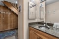 Step into your private retreat with a spacious granite vanity, double mirror setup, and warm wood finishes that blend rustic charm with modern convenience.