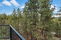 Upstairs primary private balcony. Step onto your private balcony and breathe in the fresh mountain air while towering pines frame your peaceful forest retreat.