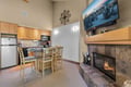 Cozy up by the fireplace after a day on the slopes, with your open kitchen and dining space ready for easy meal prep and gatherings.