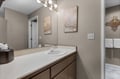 Freshen up in your private bathroom with warm wood vanity, bright vanity lighting, and thoughtful Oregon-themed decor.