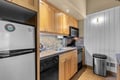 Your fully equipped kitchen features warm wood cabinetry, granite countertops, and modern appliances ready for your culinary adventures. Bright and inviting, it's a perfect space to prepare home-cooked meals during your stay.