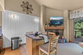 Gather around the cozy breakfast bar and watch flames dance in the fireplace as you sip your morning coffee. Natural light streams through sliding doors, while the open layout invites you to relax and feel at home.