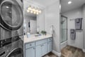Fresh towels await in your private bathroom, complete with a modern shower-tub and in-unit washer and dryer for your convenience.