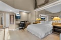 B unit work station. Unwind in your spacious loft-style bedroom with soaring ceilings, crisp linens, and a dedicated workspace for any travel planning.