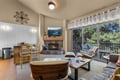 Gather around the fireplace and gaze out at towering pines framing your peaceful retreat—every corner invites you to unwind and feel at home.