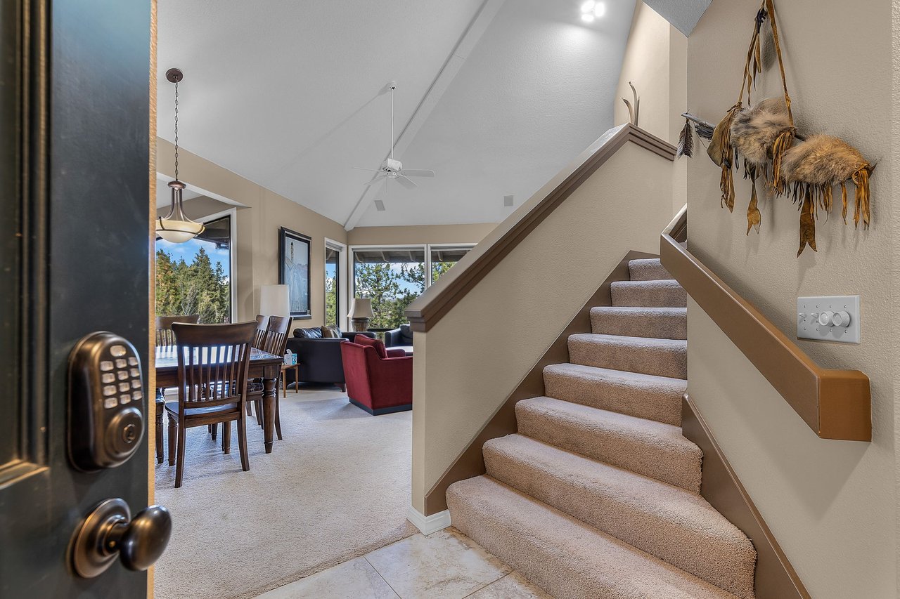 Step into your spacious retreat where warm wood tones and vaulted ceilings create an inviting atmosphere for relaxing meals and memorable gatherings.