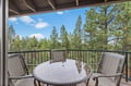 Step onto your private balcony and breathe in the forest air while enjoying meals at your outdoor table surrounded by towering pines.