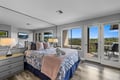 Wake up to sweeping forest views through floor-to-ceiling glass doors that open onto your private balcony, where the morning air is crisp and the pines stretch endlessly ahead.