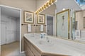 Upstairs Primary Bathroom dual sinks. You'll love this spacious bathroom with dual vanities, perfect Hollywood-style lighting, and a luxurious walk-in shower for your refreshing morning routine.